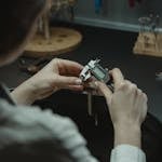 A jeweler uses a caliper to measure with precision in a professional workshop.